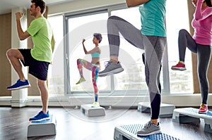 Group of people raising legs on step platforms