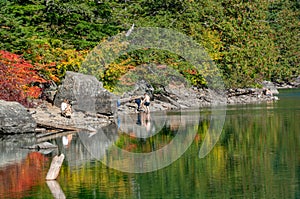 Group of people resting at Lindeman Lake, British Columbia, Canada