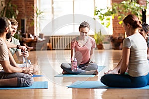 Group of people resting on yoga mats at studio