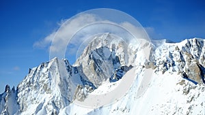 a group of people riding skis down a snow covered slope