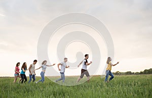 Group of people running in the grass,