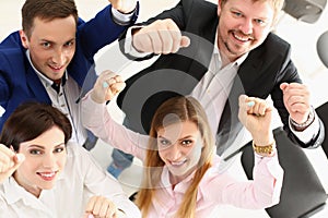 Group of people show support gesture collectively in office