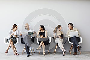 Group of people sitting on chairs photo