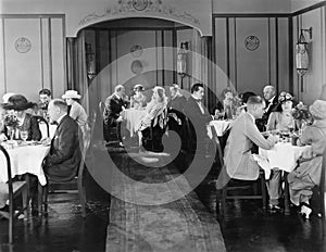 Group of people sitting in a restaurant having dinner