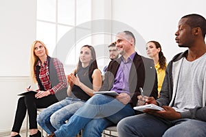 Group of people sitting at seminar, copy space