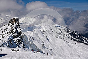 A group of people skiing off piste at the Meribel ski resort.