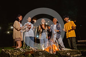 a group of people smiling while playing the fireworks