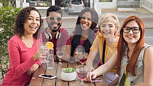 Group of people socializing in a party at restaurant outside.