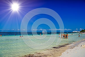 Group of people standin in the water beach on a sunny day in Cancun, Yukatan, Mexico