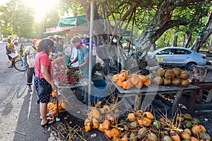 Group of People Standing Around a Fruit Stand in Mauritius