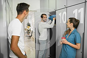 Group of people standing in the changing room and talking