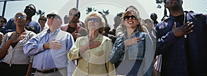 Group Of People Standing For National Anthem photo