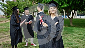 Group of people students graduated holding diploma standing with arms crossed gesture at university campus