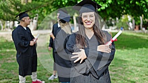 Group of people students graduated holding diploma standing with arms crossed gesture at university campus