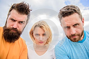 Group people suspect you. Suspicious look. Threesome suspiciously look down. Woman and men look confident sky background