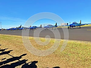 Group of people taking photographs of commercial aircraft parked on the tarmac at an airport