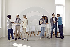 Group of people talking during casual office meeting