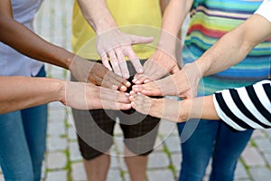 Group of people touching hands in a circle