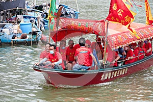 Group of people traveling with a red boat at the dragon boat festival in Taio O, Hong Kong
