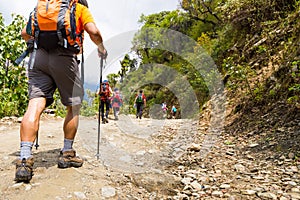 A group of people trekking on dirt road in Nepal