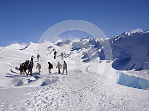 Group of people trekking on top of glacier Perito