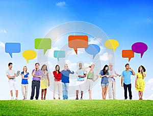 Group of People Using Devices with Speech Bubble Outdoors