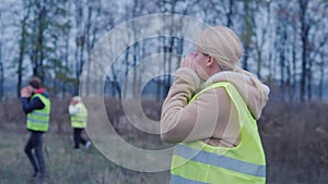 A group of people walk along the stare and shout - looking for the missing man