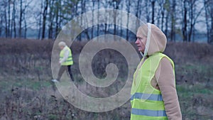 A group of people walk along the stare and shout - looking for the missing man