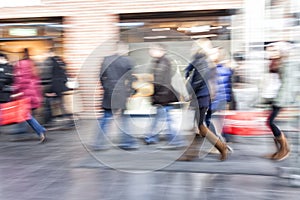 Group of people walking in shopping centre, zoom effect, motion