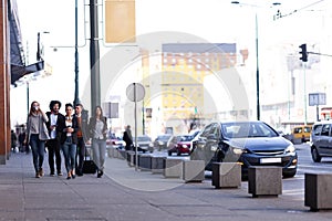 Group of people walking on a street with confidence. Businessmen and businesswomen traveling together
