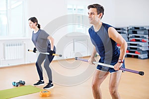 Group people warming up, doing power exercise workout in fitness club