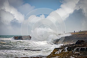 A group of people watching ocean waves