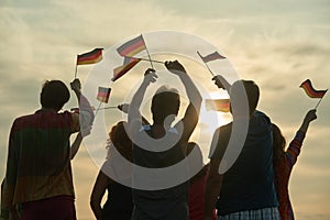 Group of people waving deutch flags.
