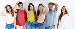 Group of people wearing casual clothes standing over isolated background confuse and wondering about question