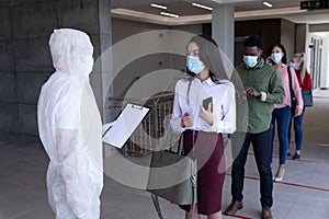 Group of people wearing face masks standing in queue