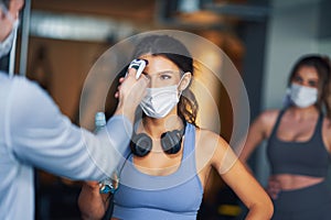Group of people wearing masks entering a gym