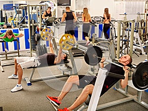 Group of people working his body at big gym