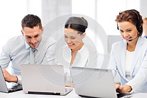 Group of people working with laptops in office