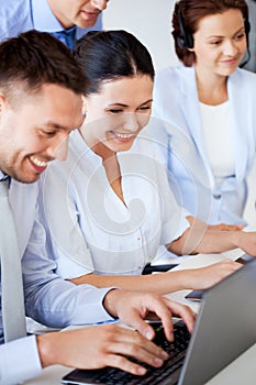 Group of people working with laptops in office