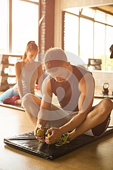 Group of people workout in healthy club. Young people stretching