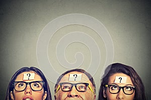 Group of people young women senior man with question mark looking up