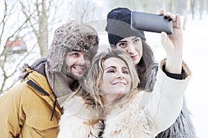 Group of person taking selfie in winter forest