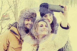Group of person taking selfie in winter forest