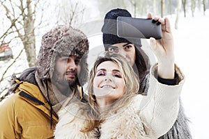 Group of person taking selfie in winter forest