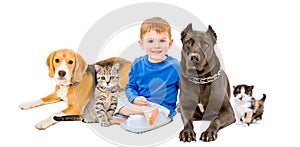 Group of pets and happy child sitting together