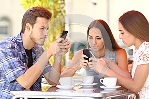 Group of phone addicted friends in a coffee shop