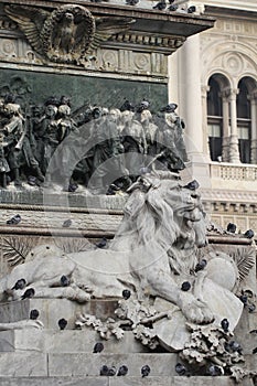 Group of Pigeons on Lion head statue at Piazza Duomo of Milano Italy, dirty from bird pooping shit on attractive sculpture art