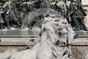 Group of Pigeons on Lion head statue at Piazza Duomo of Milano Italy, dirty from bird pooping shit on attractive sculpture art