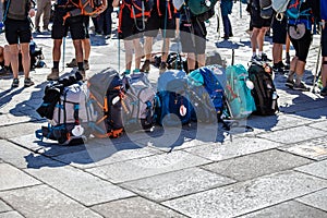 Group of Pilgrim backpack in a row on paving stone of Obradoiro square, Santiago de Compostela, Spain photo