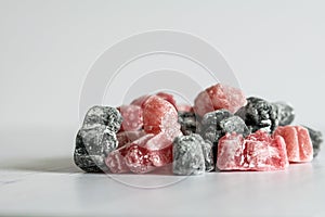 A group of pink and black jelly sweets